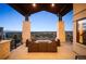 Outdoor patio area with stone columns and comfortable seating, perfect for enjoying the cityscape at 703 Emberglow Ln, Highlands Ranch, CO 80126