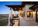 Multi-level patio with spiral staircase and stone columns featuring neighborhood views at 703 Emberglow Ln, Highlands Ranch, CO 80126