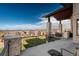 Expansive outdoor patio with stone columns offering panoramic views of the surrounding landscape at 703 Emberglow Ln, Highlands Ranch, CO 80126