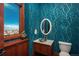 Chic powder room with a round mirror and designer wallpaper at 703 Emberglow Ln, Highlands Ranch, CO 80126