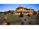 Stunning home with a covered patio, stone accents, and a beautifully landscaped backyard at 703 Emberglow Ln, Highlands Ranch, CO 80126