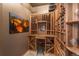 Custom wine cellar with wooden racks, countertop and stool for tasting and display at 703 Emberglow Ln, Highlands Ranch, CO 80126