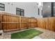 Cozy backyard with a wooden fence, artificial turf, and pebble ground cover for low maintenance at 1242 Yates St # U2, Denver, CO 80204