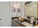 Modern bathroom with double sinks, granite countertops, gold fixtures and tiled shower at 1242 Yates St # U2, Denver, CO 80204