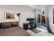 Modern bedroom features desk area, with sliding glass doors providing access to outdoor area at 1242 Yates St # U2, Denver, CO 80204