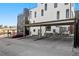 Parking area with covered parking and view of the townhome at 1242 Yates St # U2, Denver, CO 80204