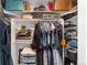 Organized walk-in closet with shelving, hanging racks, and storage for shoes and other personal items at 1242 Yates St # U2, Denver, CO 80204