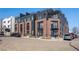 Modern multi-story brick apartment building featuring large windows and a dark metal facade at 1242 Yates St # U2, Denver, CO 80204