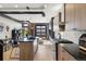 Modern kitchen featuring wooden cabinets, black countertops, island and unique industrial elements at 1242 Yates St # U2, Denver, CO 80204