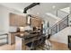 Modern kitchen featuring wood cabinetry, a black countertop island with seating, and a stainless steel range hood at 1242 Yates St # U2, Denver, CO 80204