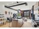 Open concept kitchen featuring an island, stainless steel appliances, and modern dining area at 1242 Yates St # U2, Denver, CO 80204