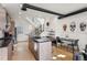 Bright kitchen with island, modern cabinets, stainless appliances, and an open concept leading to the stairs at 1242 Yates St # U2, Denver, CO 80204
