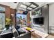 Living room with exposed brick, modern fireplace, stylish décor and a glass garage door to the outside at 1242 Yates St # U2, Denver, CO 80204