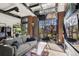 Stylish living area features a glass garage door to a balcony and fireplace with mounted television at 1242 Yates St # U2, Denver, CO 80204