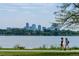 Scenic view of neighborhood and the city skyline beyond the lake, offering a peaceful setting at 1242 Yates St # U2, Denver, CO 80204