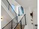 Modern staircase featuring wooden steps, black railing, white walls and natural light at 1242 Yates St # U2, Denver, CO 80204