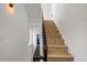 Light-filled staircase with modern railing and light hardwood steps at 1242 Yates St # U2, Denver, CO 80204