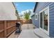 Enclosed backyard with BBQ, patio with stepping stones, wood fence, and blue siding at 7061 Palisade Dr, Highlands Ranch, CO 80130