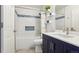 Bright bathroom featuring a modern vanity with white countertops, blue cabinets, and updated lighting at 7061 Palisade Dr, Highlands Ranch, CO 80130