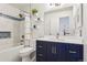 Bright bathroom featuring a modern vanity with white countertops, blue cabinets, and updated lighting at 7061 Palisade Dr, Highlands Ranch, CO 80130