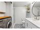 Bright bathroom with patterned floors, white vanity, toilet, and walk-in shower with glass door at 7061 Palisade Dr, Highlands Ranch, CO 80130