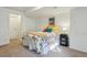 Bedroom featuring soft carpet flooring, bright bedspread, and ample natural light from the window at 7061 Palisade Dr, Highlands Ranch, CO 80130