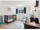 Cozy Bedroom with a crib, comfortable glider, and natural light filtering through the window at 7061 Palisade Dr, Highlands Ranch, CO 80130