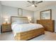 Comfortable bedroom with a bed, wooden furniture, ceiling fan, and plenty of light at 7061 Palisade Dr, Highlands Ranch, CO 80130