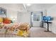 Well-lit bedroom with carpet flooring, bright comforter and a dedicated workspace with dual monitors at 7061 Palisade Dr, Highlands Ranch, CO 80130