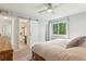 Bright bedroom features a ceiling fan, closet, and barn door to the en suite bathroom at 7061 Palisade Dr, Highlands Ranch, CO 80130