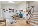 Bright dining room with hardwood floors, and staircase, accented by colorful wall art at 7061 Palisade Dr, Highlands Ranch, CO 80130