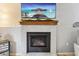 Modern fireplace with mantel and hearth, underneath a large screen TV at 7061 Palisade Dr, Highlands Ranch, CO 80130