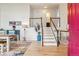 Bright foyer with hardwood floors, staircase, and stylish décor, creating a welcoming entrance at 7061 Palisade Dr, Highlands Ranch, CO 80130
