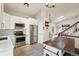 Modern kitchen with white cabinets, stainless steel appliances, and stylish tile flooring at 7061 Palisade Dr, Highlands Ranch, CO 80130