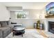 Cozy living room features a fireplace, large screen tv, and lots of seating at 7061 Palisade Dr, Highlands Ranch, CO 80130