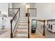 Staircase featuring light wood treads, white risers, and natural wood railing leading to a living area at 7061 Palisade Dr, Highlands Ranch, CO 80130