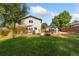 Spacious backyard with a large lawn and patio area at 927 Quartz Ct, Longmont, CO 80504