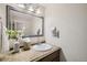 Stylish bathroom with a vanity, mirror, and decorative vase at 927 Quartz Ct, Longmont, CO 80504