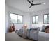 Bright bedroom featuring large windows with wood trim, a ceiling fan and neutral tones at 680 Lone Eagle Dr, Granby, CO 80015