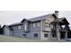 Striking multi-level house featuring a stone foundation and a covered outdoor seating area at 680 Lone Eagle Dr, Granby, CO 80015