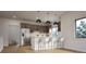 Modern kitchen featuring stainless steel appliances, wood cabinets, a breakfast bar, and hardwood floors at 680 Lone Eagle Dr, Granby, CO 80015