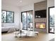 Bright living room featuring a fireplace, large windows with view and stylish decor at 680 Lone Eagle Dr, Granby, CO 80015