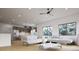Bright living room featuring hardwood floors, large windows, and a modern kitchen in an open-concept design at 680 Lone Eagle Dr, Granby, CO 80015