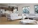 Bright living room featuring hardwood floors, large windows, and a modern kitchen in an open-concept design at 680 Lone Eagle Dr, Granby, CO 80015
