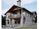 Attractive home showcasing a walkout basement, patio with fire pit, and an inviting covered balcony above at 680 Lone Eagle Dr, Granby, CO 80015