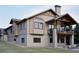 An impressive view of a home featuring a walkout basement, large patio, and a cozy balcony above at 680 Lone Eagle Dr, Granby, CO 80015