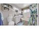 Cozy bathroom featuring a toilet, vanity, and a tub-shower combo with a decorative shower curtain at 6725 W 84Th Way # 67, Arvada, CO 80003