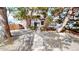 Exterior of the townhome with a concrete staircase leading to the front door, surrounded by decorative rocks and trees at 6725 W 84Th Way # 67, Arvada, CO 80003