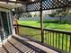 Covered porch with view of large fenced-in yard and greenery at 2619 S Iris Ct, Lakewood, CO 80227
