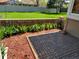 A lush backyard with a brick wall, flower bed, mulch, and grass, perfect for relaxing or entertaining guests at 2619 S Iris Ct, Lakewood, CO 80227